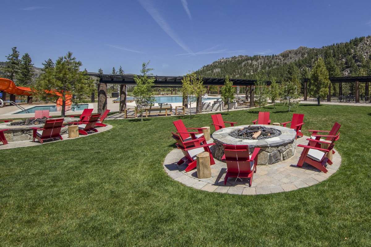 Multiple gas fire pits rest beside the pool and recreation area at the Summit Camp of Carson City’s exclusive Clear Creek Tahoe community.