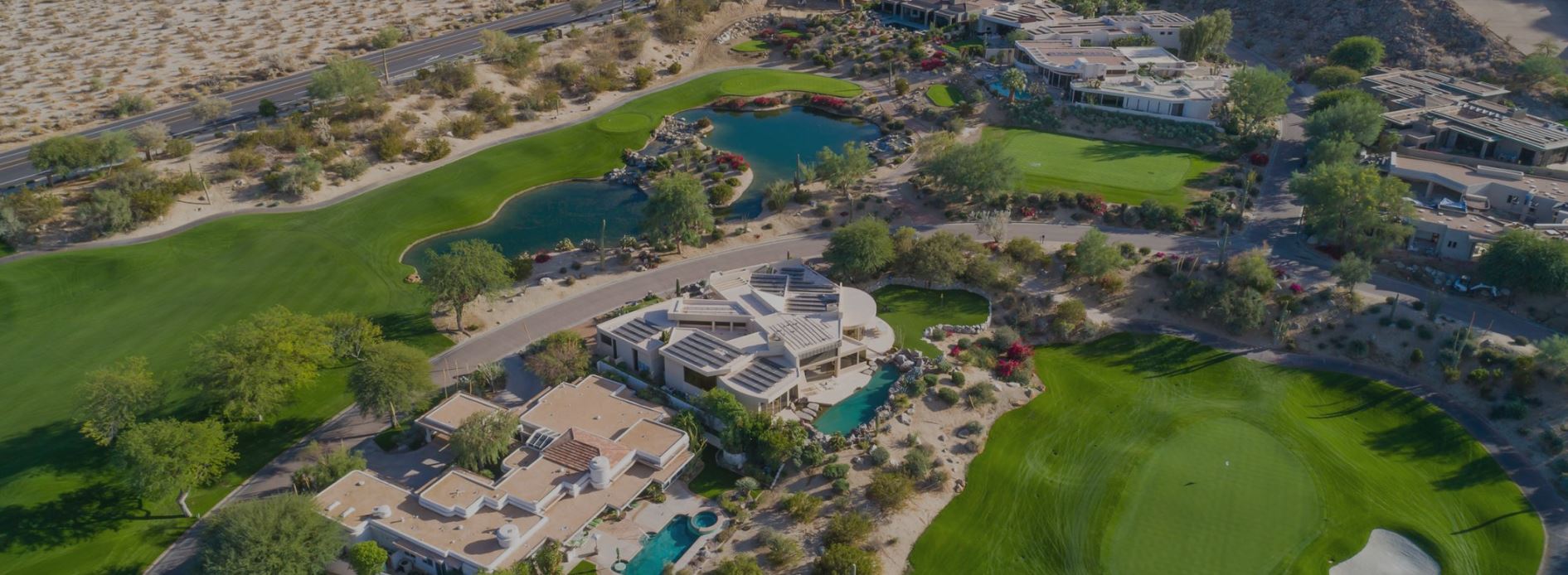 aerial photo of the big horn golf club. desert setting with a clubhouse and golf course nestled into the neutral colors of the desert's sand and landscape