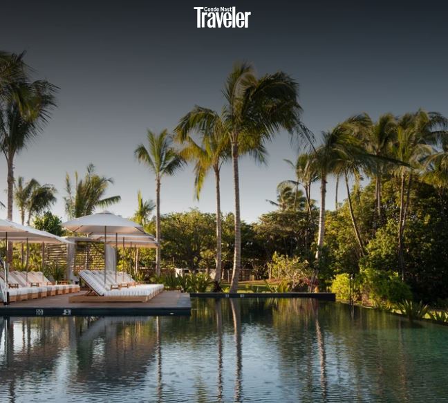 conde nast travel logo over a luxurious hawaiin setting with a large infinity pool, palm trees and lush green surround