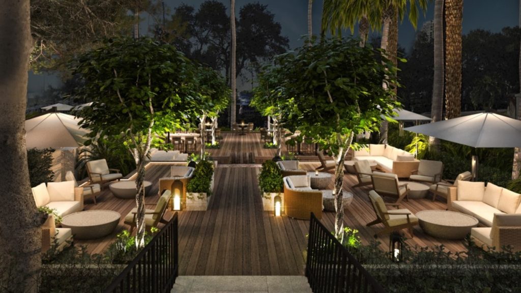 exterior rendering of an outdoor lounge space at nice with lush greenery and comfy patio seating in neutral tones