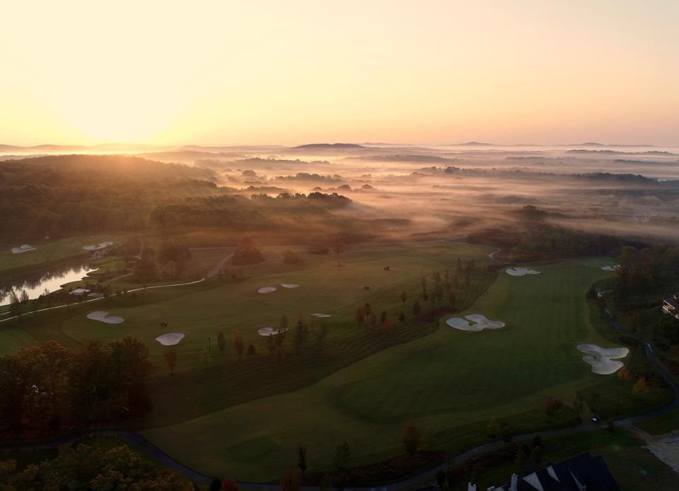 sunset aerial of a golf course set in the obvious souther region of the united states with regionally appropriate plantings