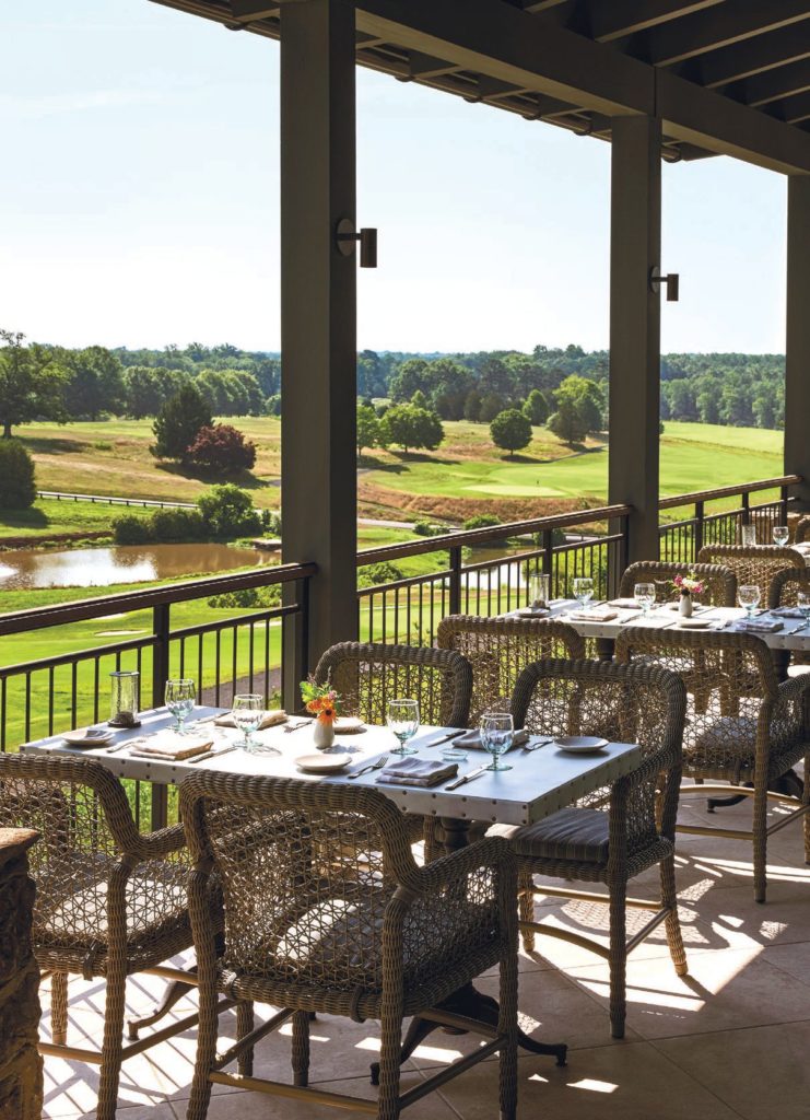 balcony outdoor restaurant seating overlooking a golf course