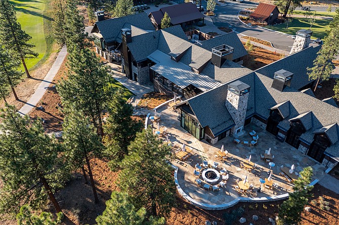 aerial perspective of a private club built in a woodsy style and set amongst pine trees